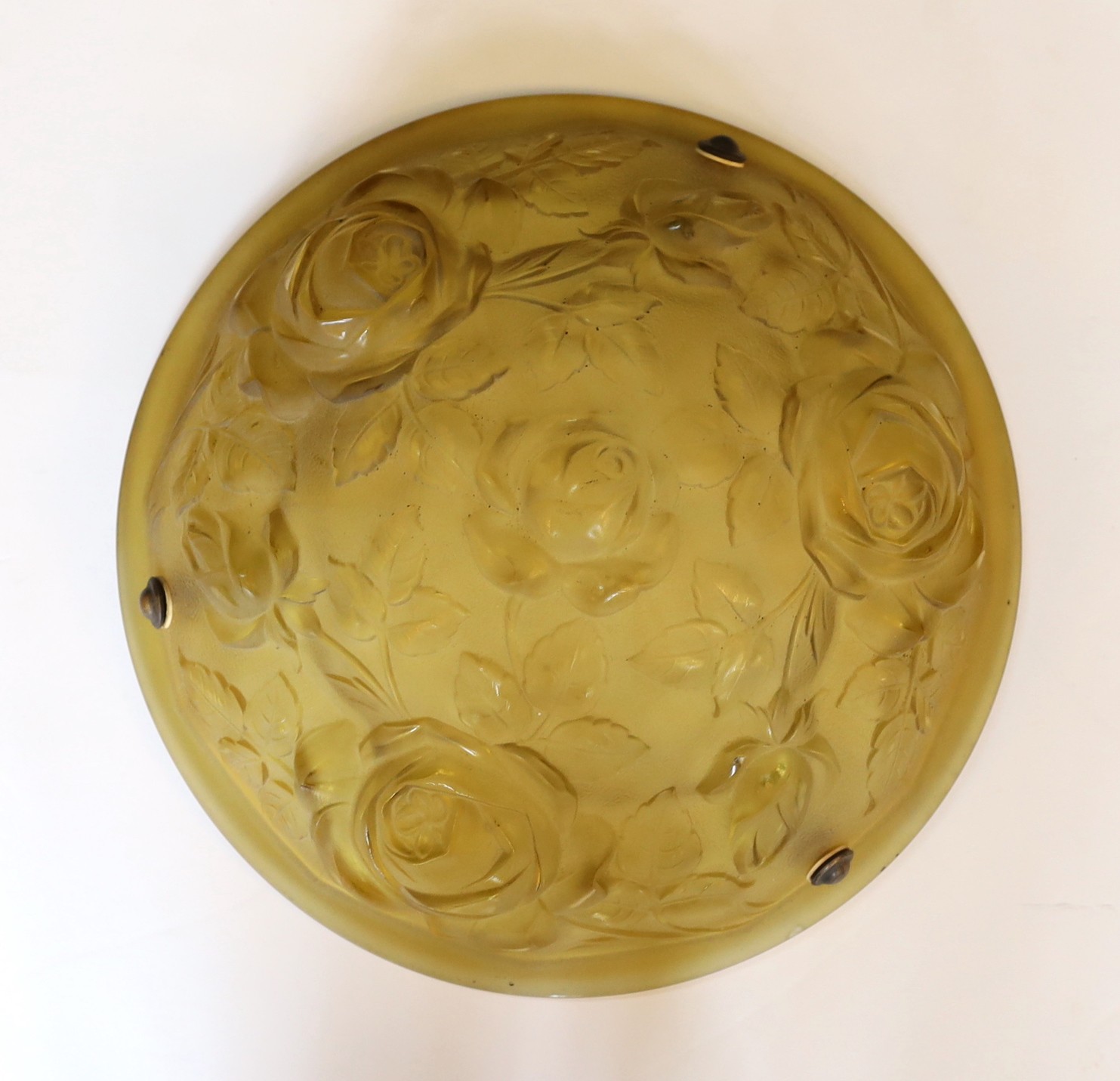 A 1920s French moulded amber glass light bowl, decorated with roses, with chain set and ceiling rose, diameter 35cm